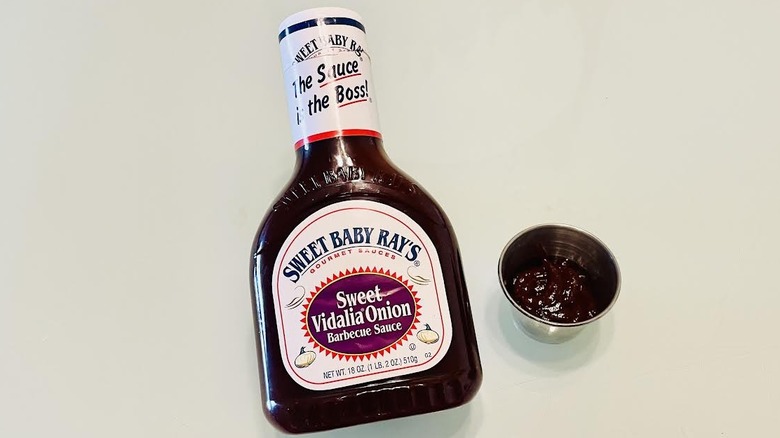Bottle of Sweet Baby Ray's Sweet Vidalia Onion Barbecue Sauce with ramekin on side