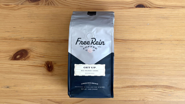Free Rein coffee bag lying flat on wooden table