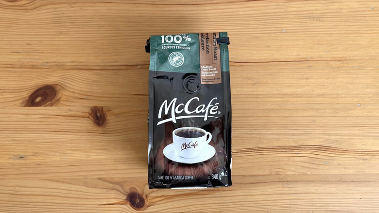 McCafe coffee bag lying flat on wooden table