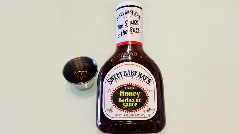 Bottle of Sweet Baby Ray's Honey Barbecue Sauce with ramekin on side