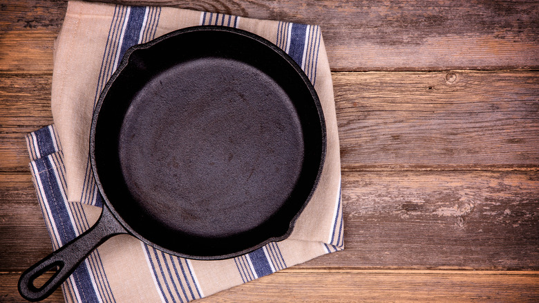 new cast iron pan pictured on towel