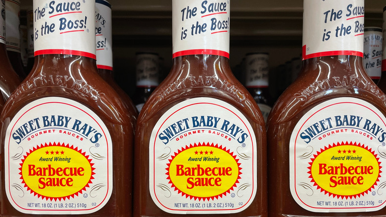 Three bottles of Sweet Baby Ray's award-winning barbecue sauce on a store shelf