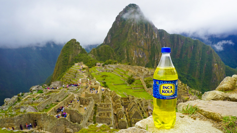 Bottle of Inca Kola in front of Machu Picchu