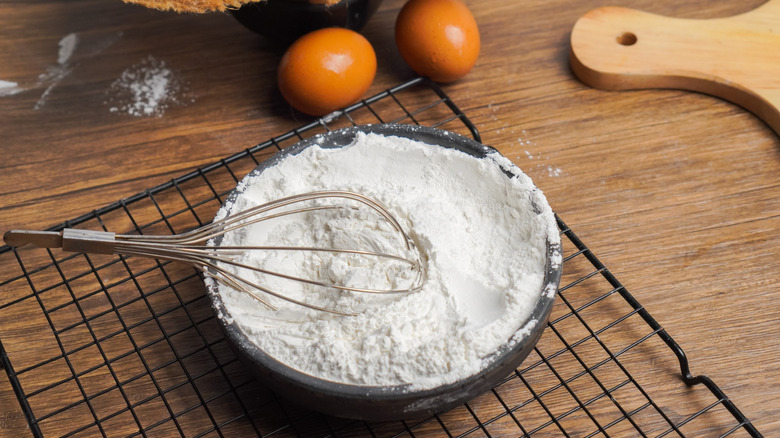 Wire cooling rack with bowl of flour and eggs