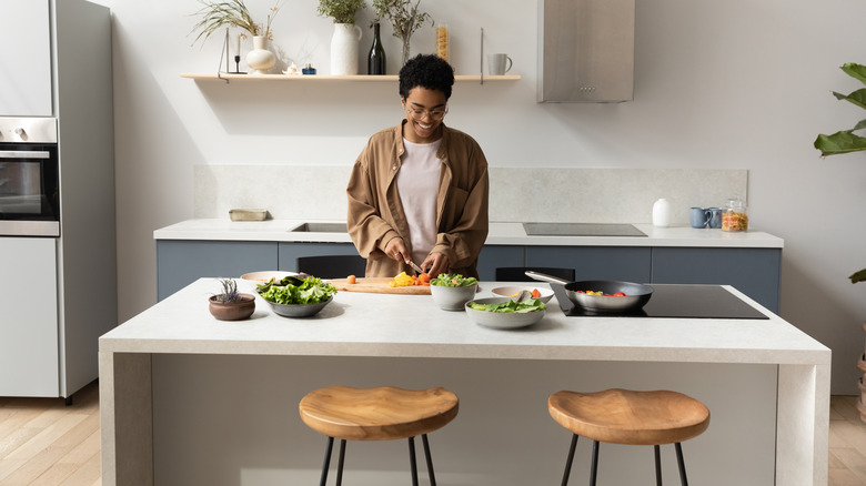 kitchen island with food in bowls and two chairs in front of it