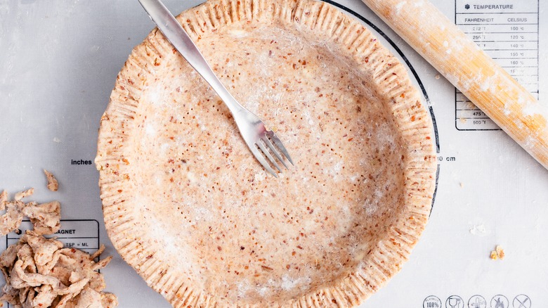 Pie crust with fork and trimmings