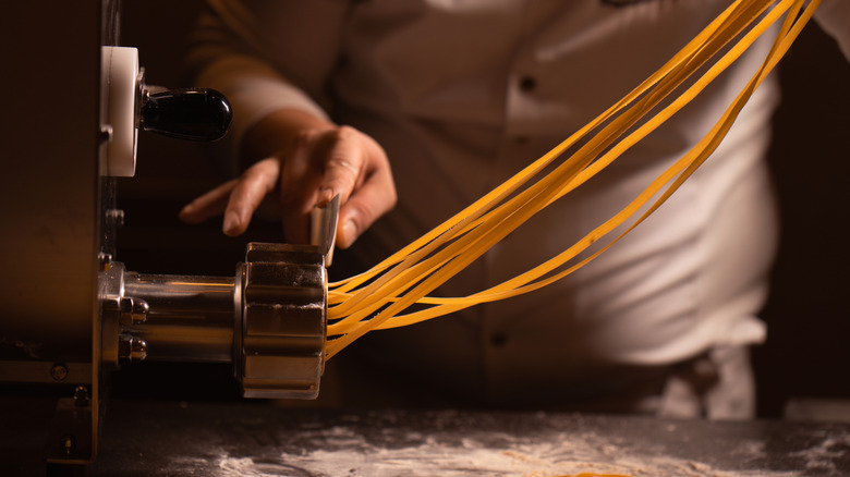 Pasta being extruded from a pasta maker