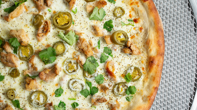 Alfredo pizza with spicy peppers and herbs