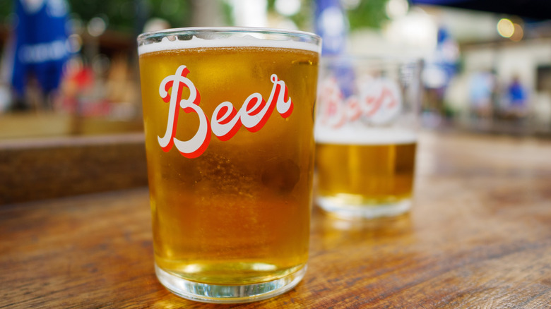 Motifed glasses of lager on table
