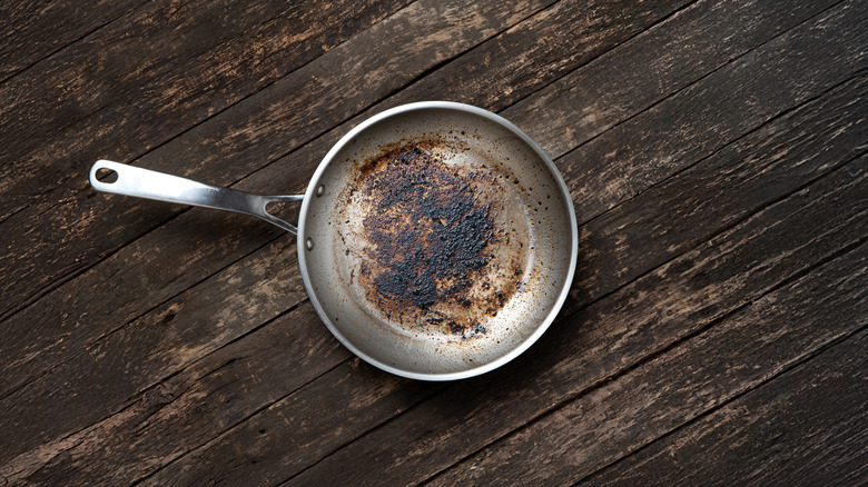Dirty aluminum fry pan with handle