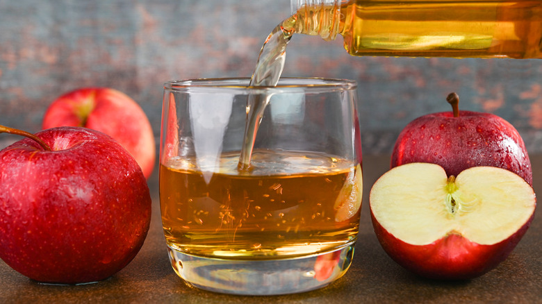 Apple juice pouring into glass