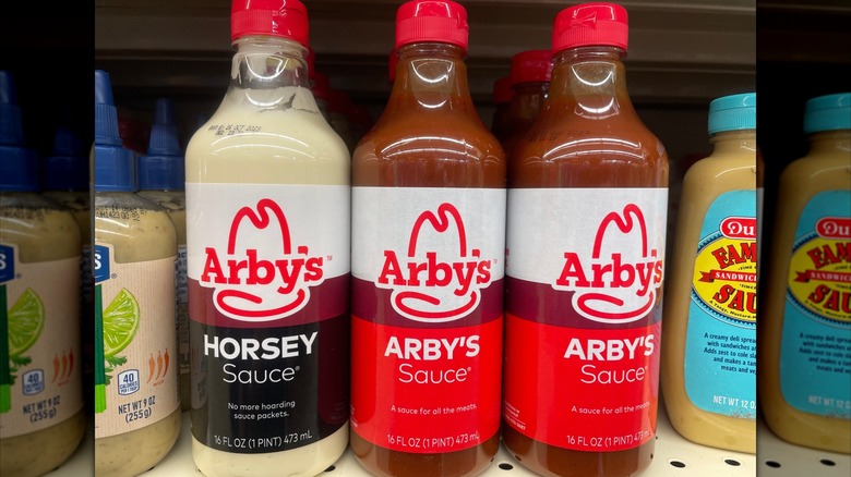 Bottles of Arby's Horsey Sauce and Arby's signature sauce in a grocery store