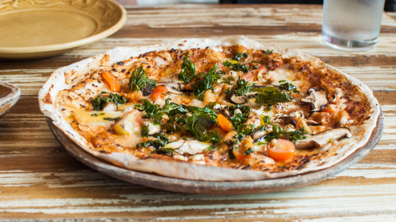 Pesto and mushroom pizza on tortilla crust