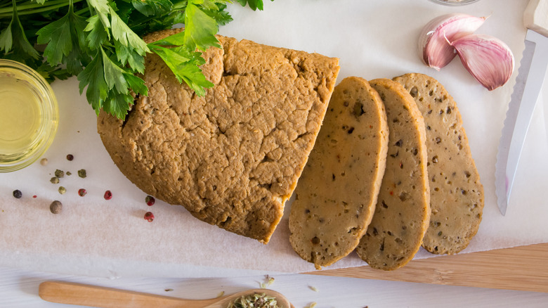 Seitan or vegan meat sliced with spices such as oregano, pepper, garlic, and parsley.