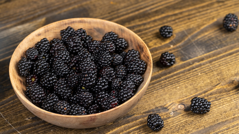 Bowl of blackberries on wooden table
