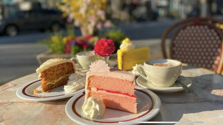 Slices of colorful cake and coffees from Café Intermezzo