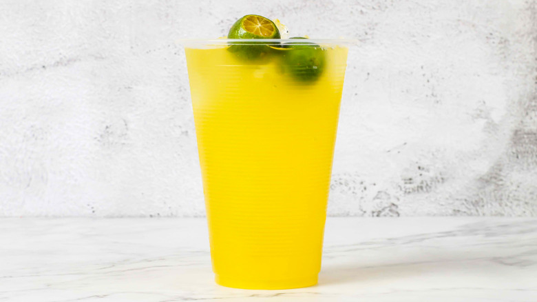 Glass of calamansi juice on marble countertop