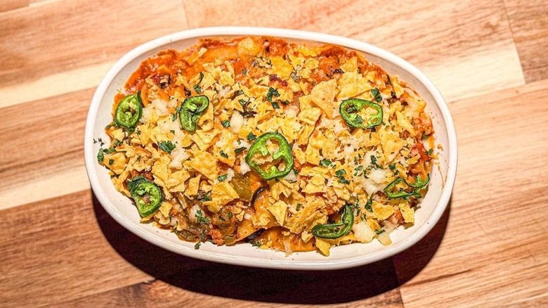 1-pot turkey taco pasta in casserole dish with tortilla chip and jalapeño garnish