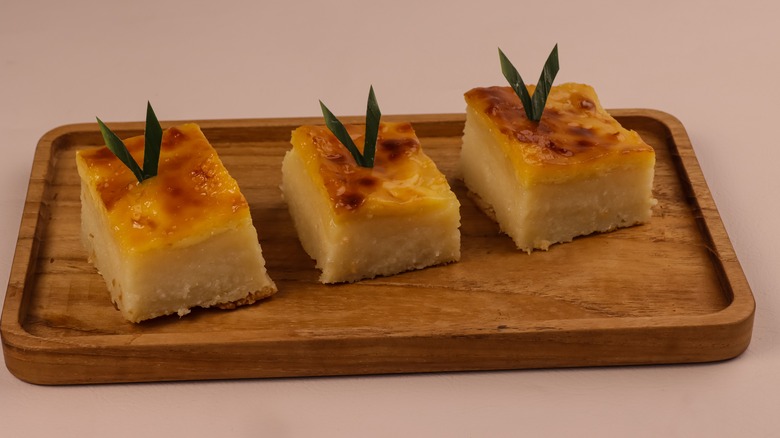 Sliced cassava cake on wooden plate