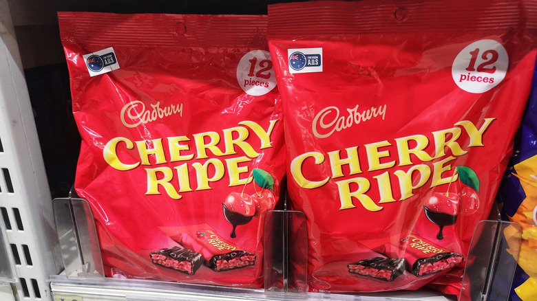 Bags of Cadbury Cherry Ripe chocolate bars on a shelf at a store