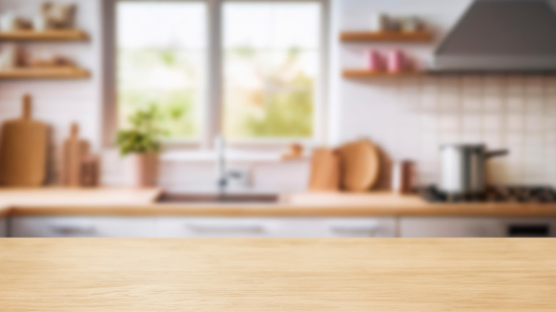 wooden kitchen island countertop with blurred background