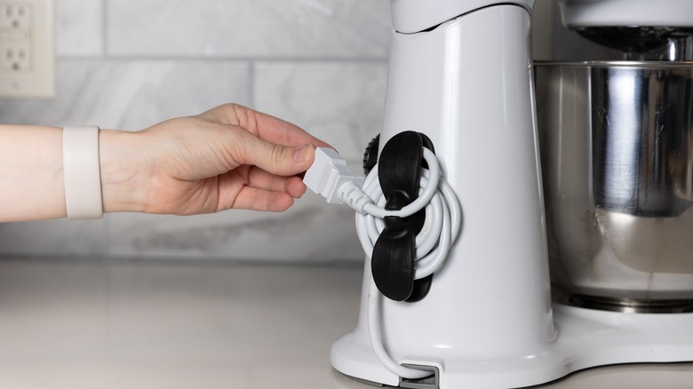 A stand mixer with a cord organizer installed
