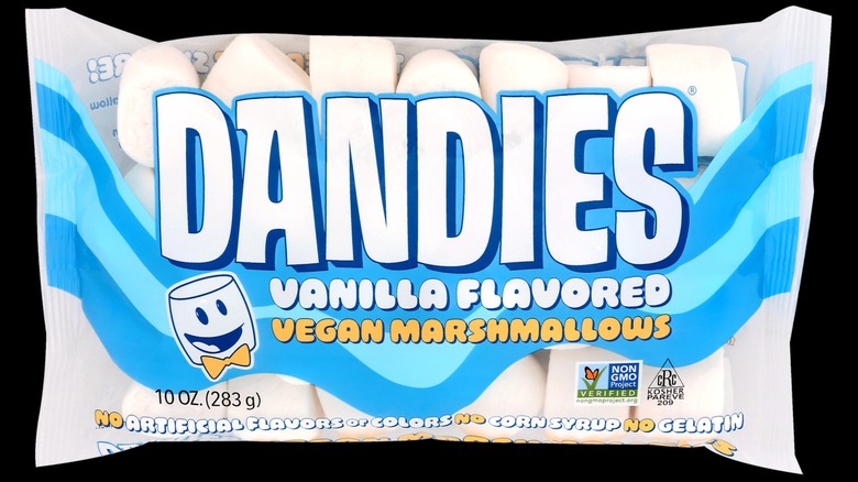 A bag of Dandies vanilla flavored marshmallows on a black background