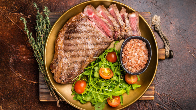 A steak with a bright, crisp salad on the side