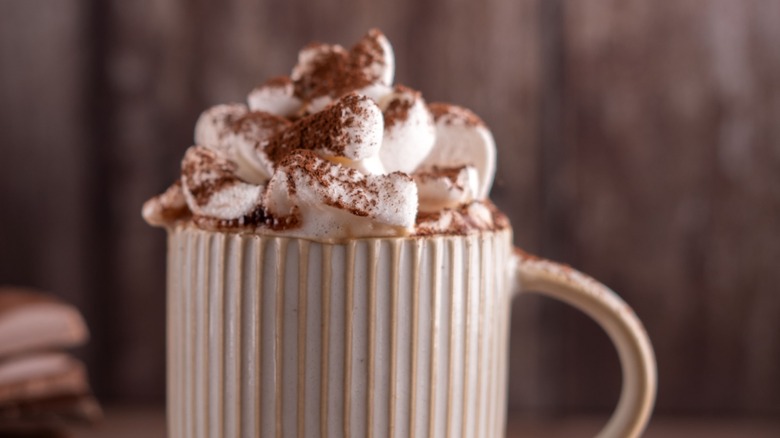 cup with marshmallows and cocoa powder on top