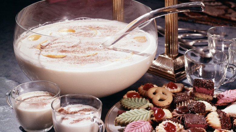 Pouring and whisking eggnog in glass bowl