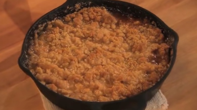 A cast iron skillet filled with freshly baked apple crisp