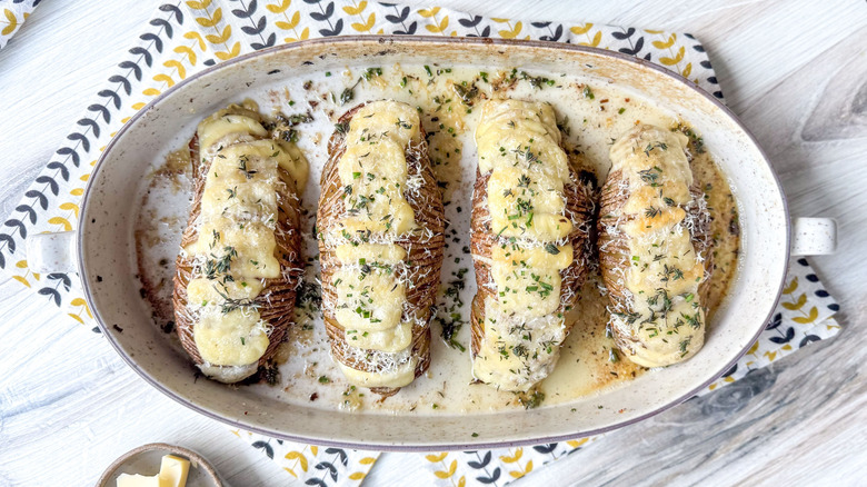 Extra cheesy Hasselback potatoes in serving dish