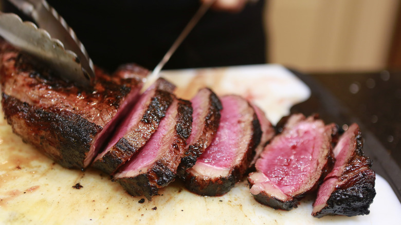 cutting up prepared beef tenderloin