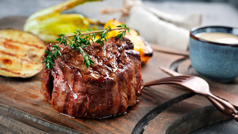 Cooked filet mignon on board