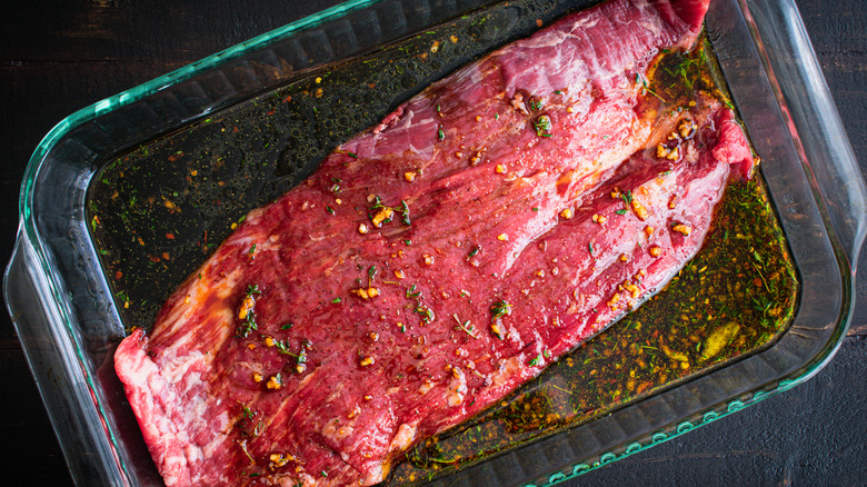 raw flank steak marinating