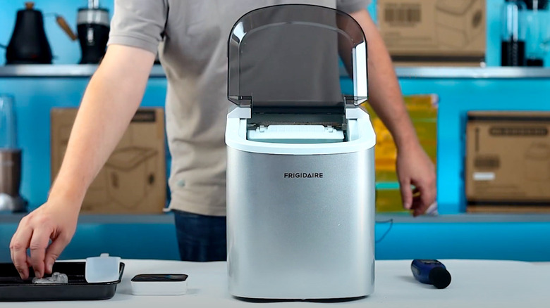 Person using Frigidaire Ice Maker Model EFIC189