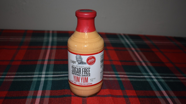 yellow sauce in a bottle with red top