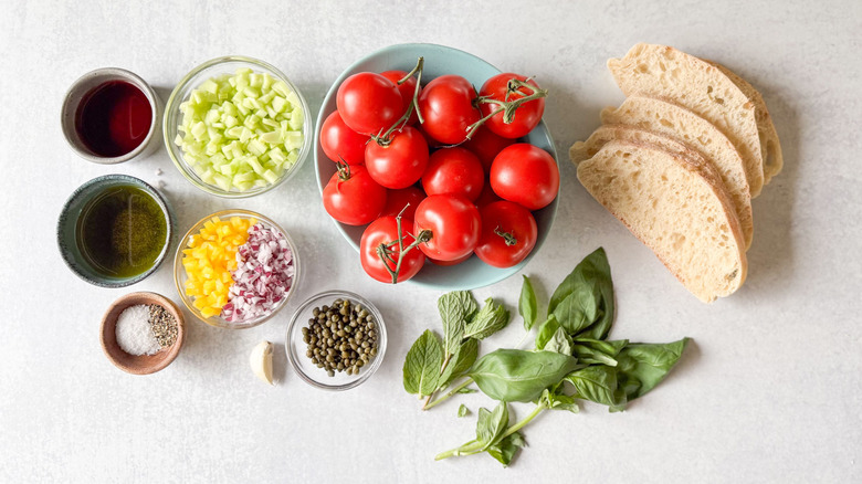 Bite-sized panzanella stuffed tomatoes ingredients on countertop