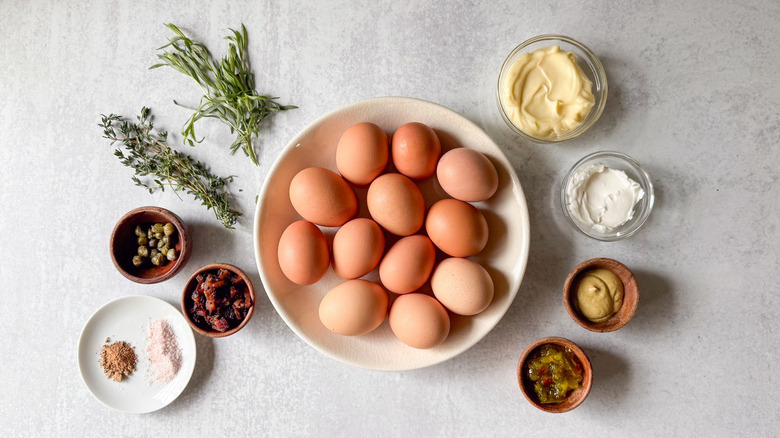 Trio of deviled eggs ingredients on countertop