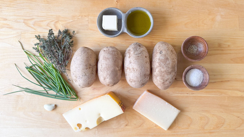Extra cheesy Hasselback potatoes ingredients on cutting board