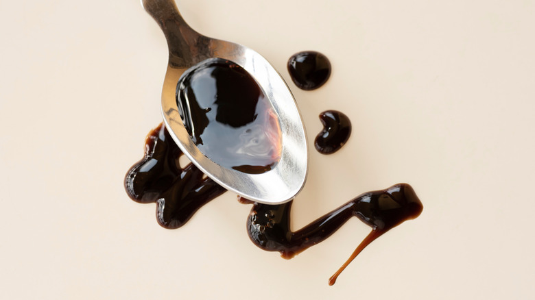 A spoon drizzling balsamic vinegar