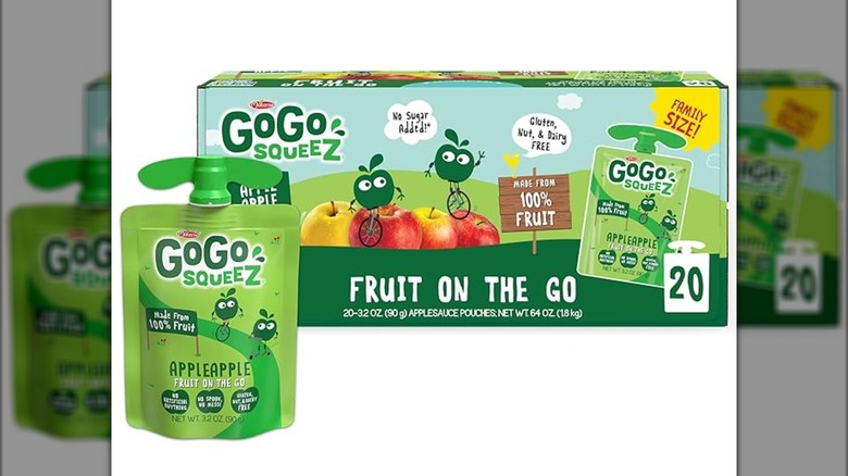 A squeeze pounch of GoGo SqueeZ applesauce in front of a large box of applesauces