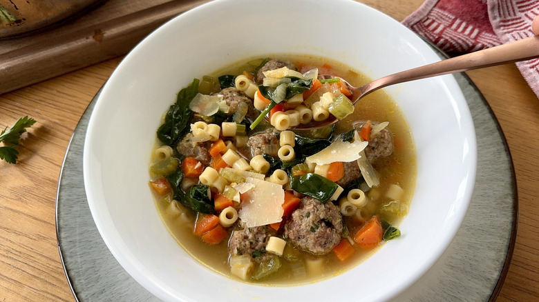 vegetable, meatball, and pasta soup in white bowl