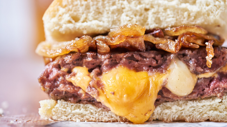 cheese melting out of hamburger