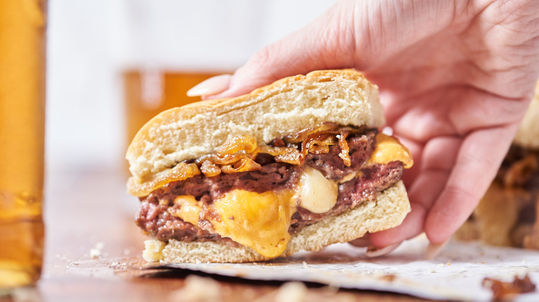 picking up a hamburger
