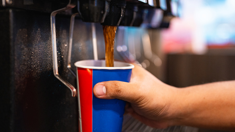 A person getting a fountain soda