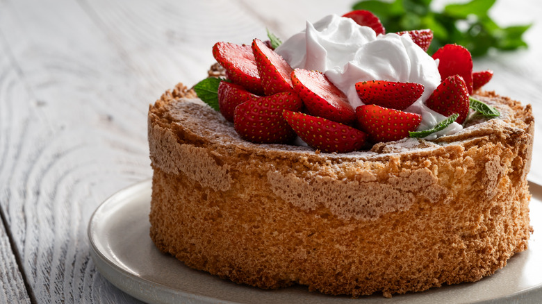 Angel food cake topped with berries and whipped cream