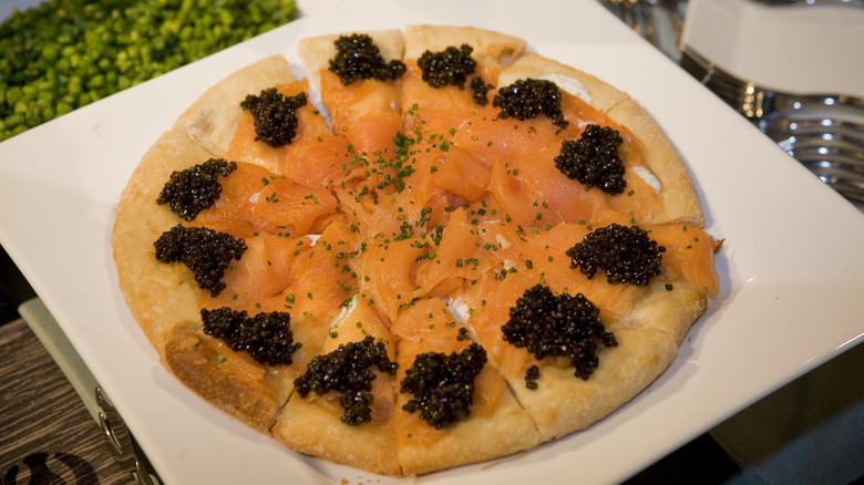 Smoked salmon pizza with caviar on a plate