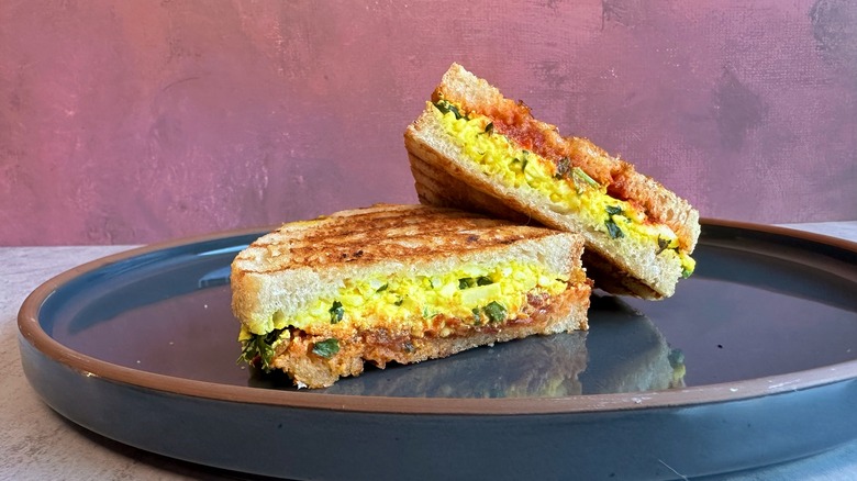 halved paneer sandwich on plate