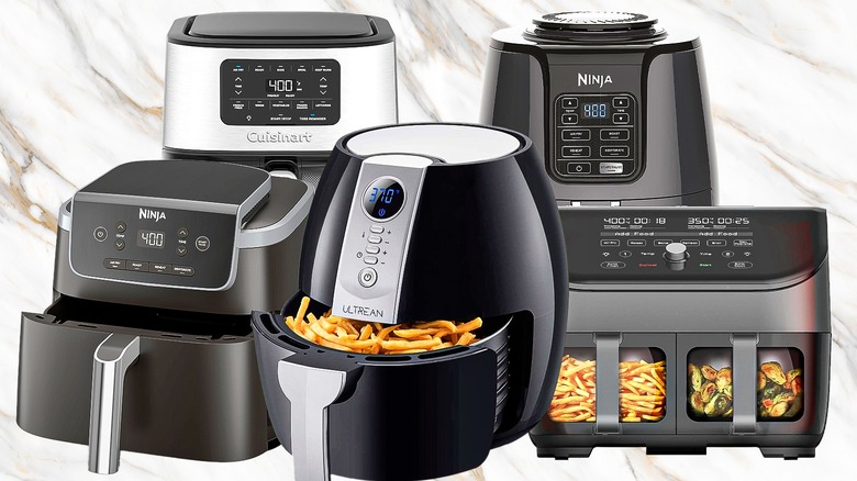 Selection of air fryers against marble effect background